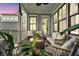Inviting outdoor porch with comfortable seating, plants, and a serene atmosphere at 164 River Green Pl, Charleston, SC 29492