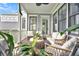 Relaxing porch with comfortable seating, ceiling fan, and views of lush greenery at 164 River Green Pl, Charleston, SC 29492