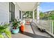 Relaxing porch with comfortable seating, unique decor, and an inviting outdoor living space overlooking lush greenery at 164 River Green Pl, Charleston, SC 29492