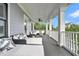 An elevated porch has multiple seating arrangements at 164 River Green Pl, Charleston, SC 29492