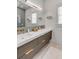 Modern bathroom with double vanity, wood drawers, brass fixtures, and a large mirror at 179 Wentworth St, Charleston, SC 29401