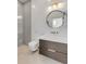 Modern bathroom with a sleek vanity, round mirror, and walk-in shower at 179 Wentworth St, Charleston, SC 29401