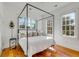 Bright bedroom with a four-poster bed, hardwood floors, and ample natural light at 179 Wentworth St, Charleston, SC 29401