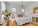 Bright bedroom with hardwood floors, white walls, fireplace and large windows at 179 Wentworth St, Charleston, SC 29401
