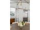 Open dining area with a modern chandelier, stainless steel refrigerator, and white cabinets at 179 Wentworth St, Charleston, SC 29401