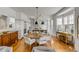 Beautiful dining room with a round table, stylish lighting, and an open layout to the kitchen at 179 Wentworth St, Charleston, SC 29401