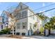 Charming two-story home featuring a white exterior with mint-colored shutters and a well-manicured front yard at 179 Wentworth St, Charleston, SC 29401
