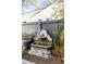 Backyard fountain with stone finish, string lights, wooden fence, and lush plants create a peaceful outdoor oasis at 179 Wentworth St, Charleston, SC 29401