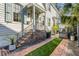 Charming front porch with brick stairs and wrought iron railings, leading to a well-manicured walkway at 179 Wentworth St, Charleston, SC 29401
