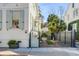 Inviting front yard showcasing a charming gate, a brick pathway, and beautiful landscaping at 179 Wentworth St, Charleston, SC 29401