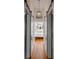 Hallway featuring white sliding barn doors, hardwood floors, and a decorative pendant light at 179 Wentworth St, Charleston, SC 29401