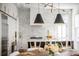 Modern kitchen featuring white cabinets, brick backsplash, gold accents, and pendant lighting above island at 179 Wentworth St, Charleston, SC 29401
