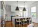 Stylish kitchen with an island, bar stool seating, and modern pendant lights above at 179 Wentworth St, Charleston, SC 29401