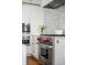 Modern kitchen appliances featuring a stainless steel oven and sleek white cabinetry at 179 Wentworth St, Charleston, SC 29401