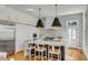 Bright, modern kitchen with stainless steel appliances, an island, and stylish pendant lighting at 179 Wentworth St, Charleston, SC 29401