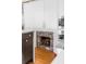 Stylish kitchen design with stainless steel appliances, white cabinets, and a charming fireplace at 179 Wentworth St, Charleston, SC 29401