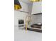 Bright, modern kitchen with white cabinets, marble countertop, and gold faucet at 179 Wentworth St, Charleston, SC 29401