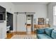 Bright living room featuring a sliding barn door, hardwood floors, and tasteful decor at 179 Wentworth St, Charleston, SC 29401