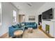 Spacious living room with a comfortable blue sectional sofa, fireplace, and hardwood floors at 179 Wentworth St, Charleston, SC 29401