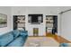 Inviting living room offers built-in workstations and a fireplace with mounted TV above at 179 Wentworth St, Charleston, SC 29401