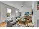 Inviting living room with stylish decor, ample seating, and natural light from large windows at 179 Wentworth St, Charleston, SC 29401