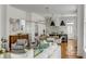Bright living room open to kitchen with hardwood floors, white walls, modern lighting, and comfortable seating at 179 Wentworth St, Charleston, SC 29401
