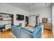 Cozy living room featuring built-in desks, fireplace, and a comfortable blue sectional sofa at 179 Wentworth St, Charleston, SC 29401