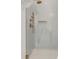 Shower stall featuring gray mosaic tile walls and bronze shower fixture at 179 Wentworth St, Charleston, SC 29401