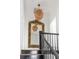 Elegant staircase with decorative mirror reflects chandelier, enhancing the home's charm at 179 Wentworth St, Charleston, SC 29401