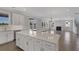 Bright, open-concept kitchen featuring white cabinets, an island, hardwood floors, and stainless appliances at 2006 Riverbend Dr, Charleston, SC 29412