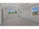 Bright bedroom featuring neutral walls and carpet, as well as natural lighting and multiple windows at 2006 Riverbend Dr, Charleston, SC 29412