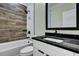 Bathroom featuring a white vanity with dark countertop, and a tub with decorative tile at 2035 Beech Ave, North Charleston, SC 29405