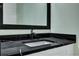 Stylish bathroom with dark countertop, white sink, and wood-framed mirror at 2035 Beech Ave, North Charleston, SC 29405