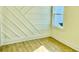 Bedroom features custom wall design, hardwood floor, and large window with natural light at 2035 Beech Ave, North Charleston, SC 29405
