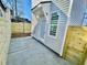 Exterior elevation showing side entrance, vinyl siding and freshly poured sidewalk at 2035 Beech Ave, North Charleston, SC 29405
