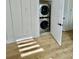 Stacked washer and dryer in laundry room with wood-look floors at 2035 Beech Ave, North Charleston, SC 29405