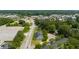 A high-angle aerial shot shows tree-lined townhomes near roads and a bustling shopping area at 204 Tyner Trl, Summerville, SC 29486