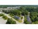 Scenic aerial view of townhomes surrounded by verdant trees, roads, and adjacent shopping centers at 204 Tyner Trl, Summerville, SC 29486