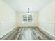 A dining room has wood floors, a chandelier, and a window with blinds at 204 Tyner Trl, Summerville, SC 29486
