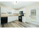 A modern kitchen with white cabinets, black appliances, and updated flooring at 204 Tyner Trl, Summerville, SC 29486