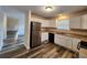 Well-lit kitchen featuring stainless steel appliances, white cabinets, and updated flooring at 204 Tyner Trl, Summerville, SC 29486