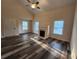 Bright living room featuring a fireplace, wood flooring, and natural light from multiple windows at 204 Tyner Trl, Summerville, SC 29486