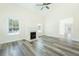 Bright living room featuring a cozy fireplace, large windows, and stylish gray flooring at 204 Tyner Trl, Summerville, SC 29486