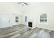 Sunlit living room features a fireplace, windows with blinds, and contemporary gray flooring at 204 Tyner Trl, Summerville, SC 29486