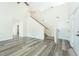 Spacious living room showcasing gray floors, a staircase, and access to other rooms at 204 Tyner Trl, Summerville, SC 29486