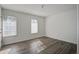 Bedroom filled with natural light from two windows, featuring modern wood-look flooring at 205 Weber Rd # B, Summerville, SC 29483