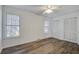 Spacious bedroom with updated wood-look flooring, a ceiling fan, and ample closet space at 205 Weber Rd # B, Summerville, SC 29483