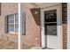Close-up of a brick townhome with white trim and a glass-paneled door at 205 Weber Rd # B, Summerville, SC 29483