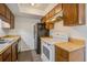 Compact kitchen features wooden cabinetry and essential appliances for convenient meal preparation at 205 Weber Rd # B, Summerville, SC 29483