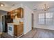 Cozy kitchen featuring wooden cabinets, white appliances, and wood-look flooring at 205 Weber Rd # B, Summerville, SC 29483